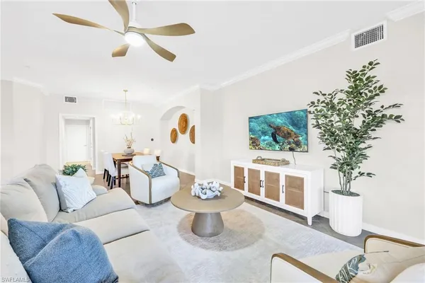 a living room with furniture and a potted plant