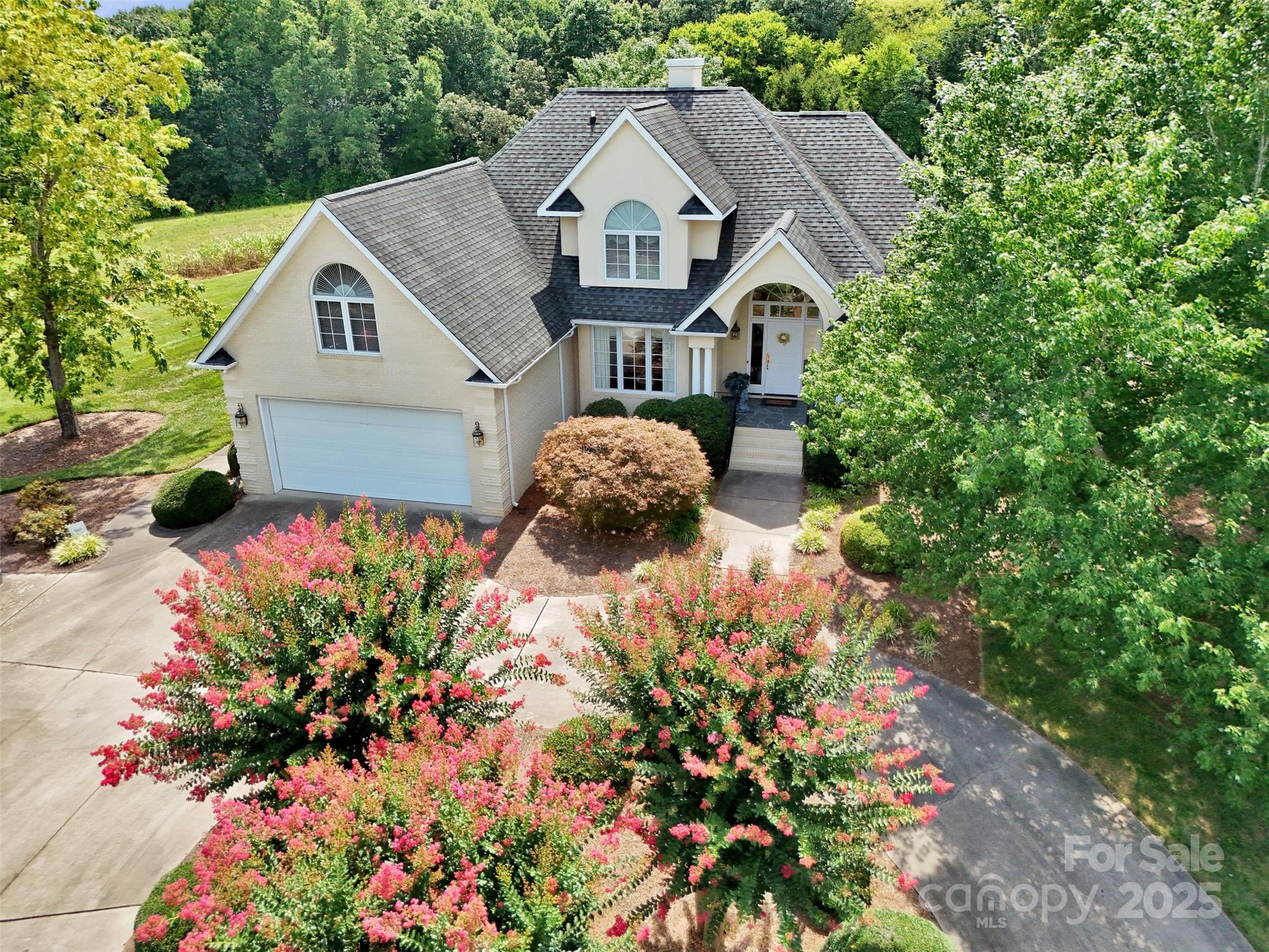 a front view of a house with a yard and garden