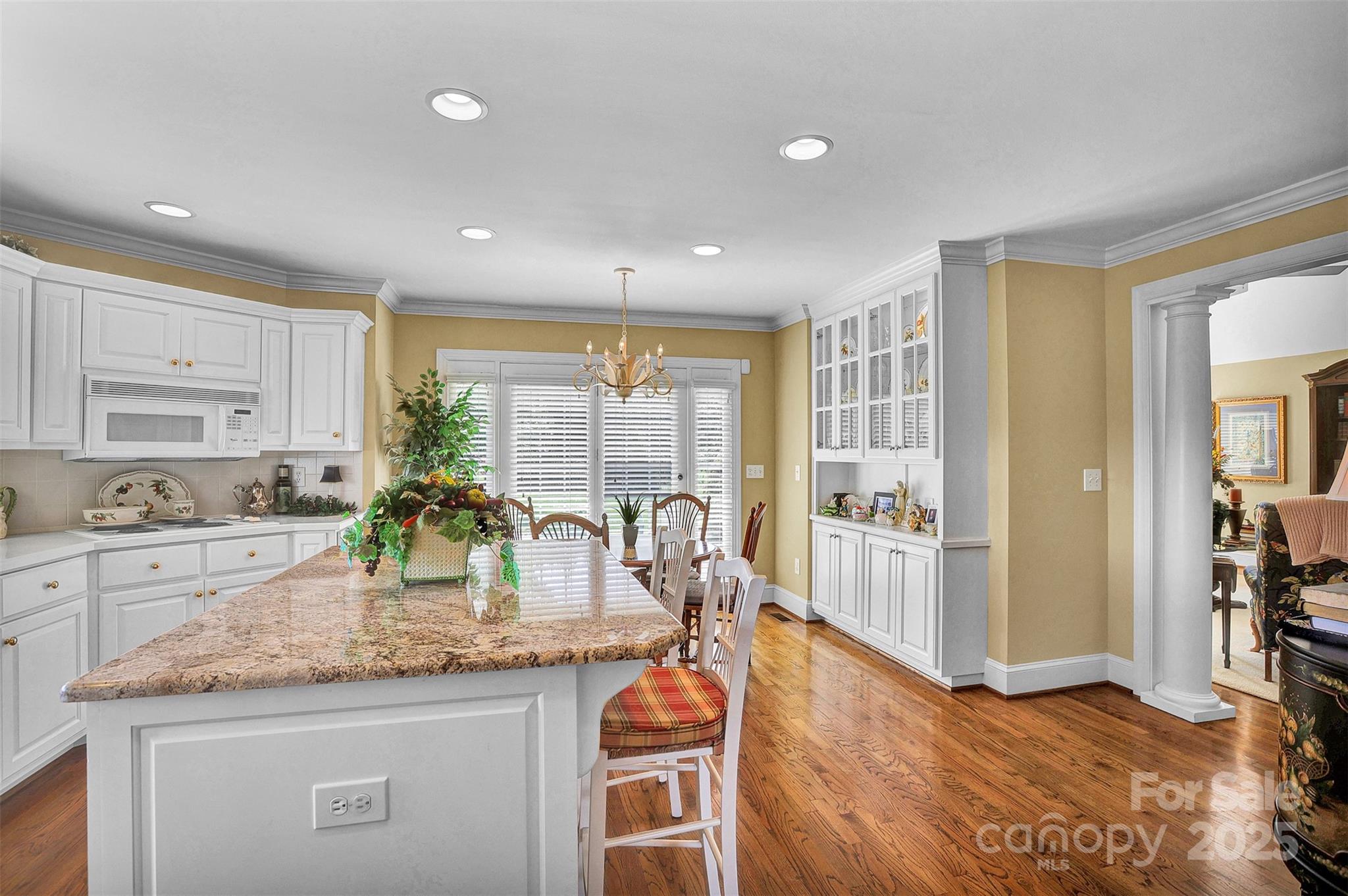 25683 April Lane Albemarle, NC 28001 - Photo 11 of 42 a kitchen with granite countertop kitchen island sink stove and wooden floor
