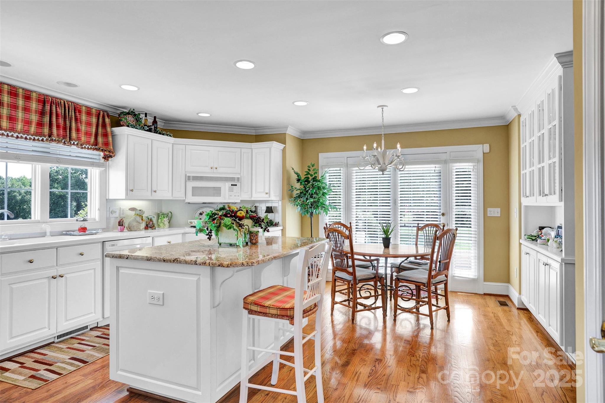 25683 April Lane Albemarle, NC 28001 - Photo 12 of 42 a kitchen with stainless steel appliances granite countertop table chairs and large windows