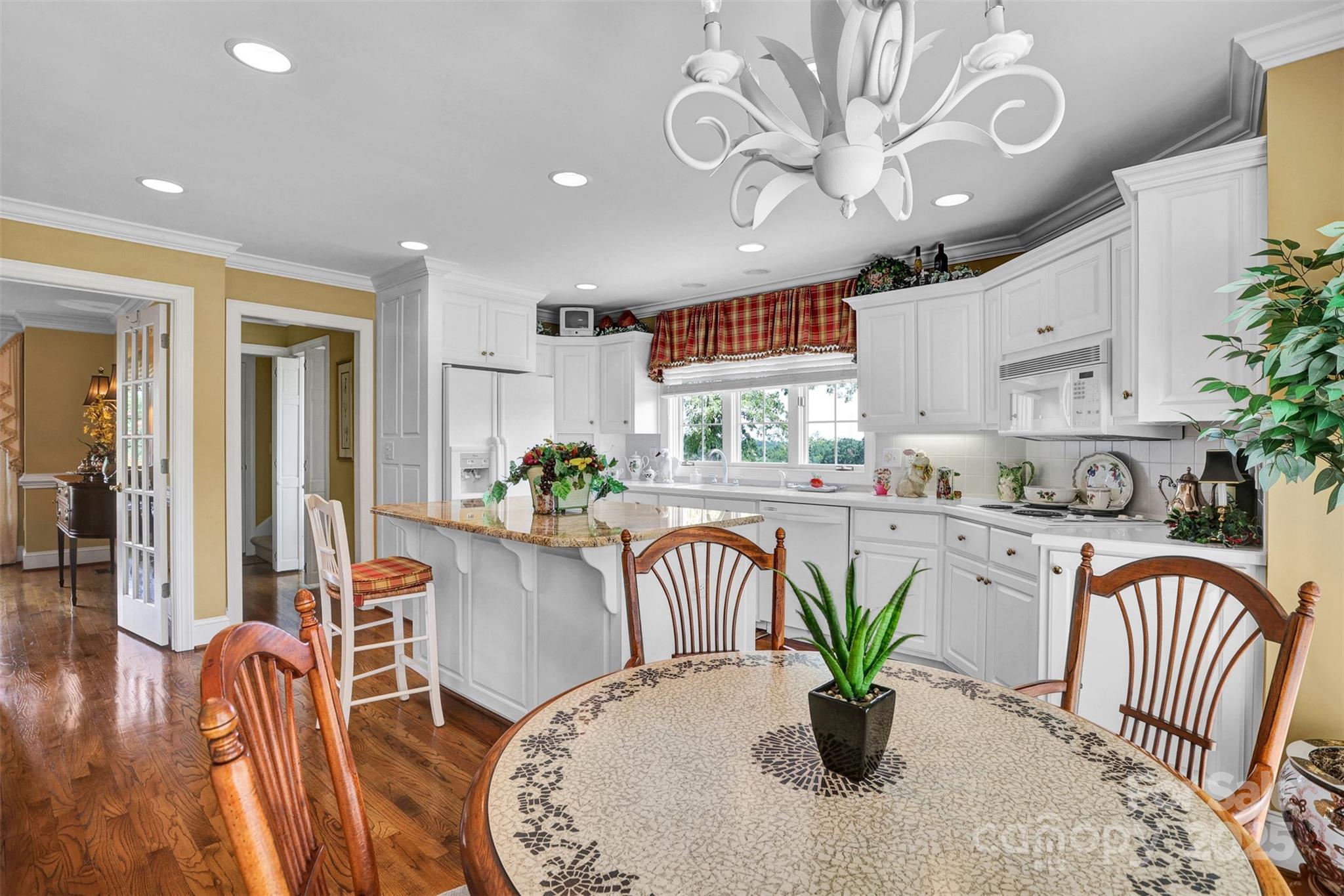 25683 April Lane Albemarle, NC 28001 - Photo 14 of 42 a dining room filled chandelier furniture and a potted plant