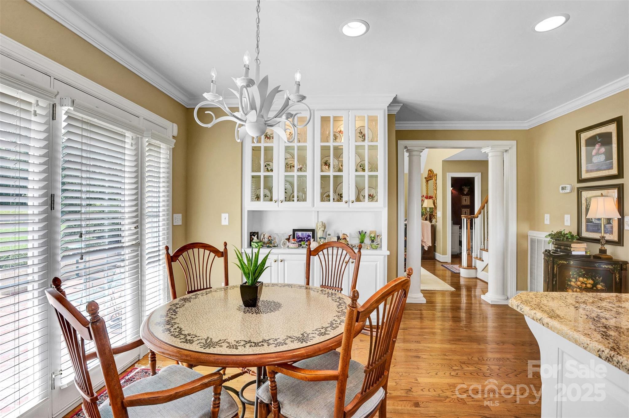 25683 April Lane Albemarle, NC 28001 - Photo 15 of 42 a dining room with furniture a chandelier and wooden floor