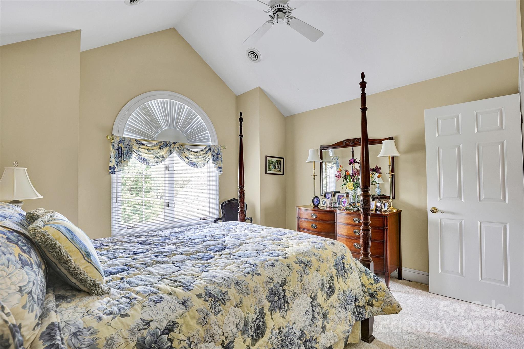 25683 April Lane Albemarle, NC 28001 - Photo 27 of 42 a spacious bedroom with a bed and a chandelier