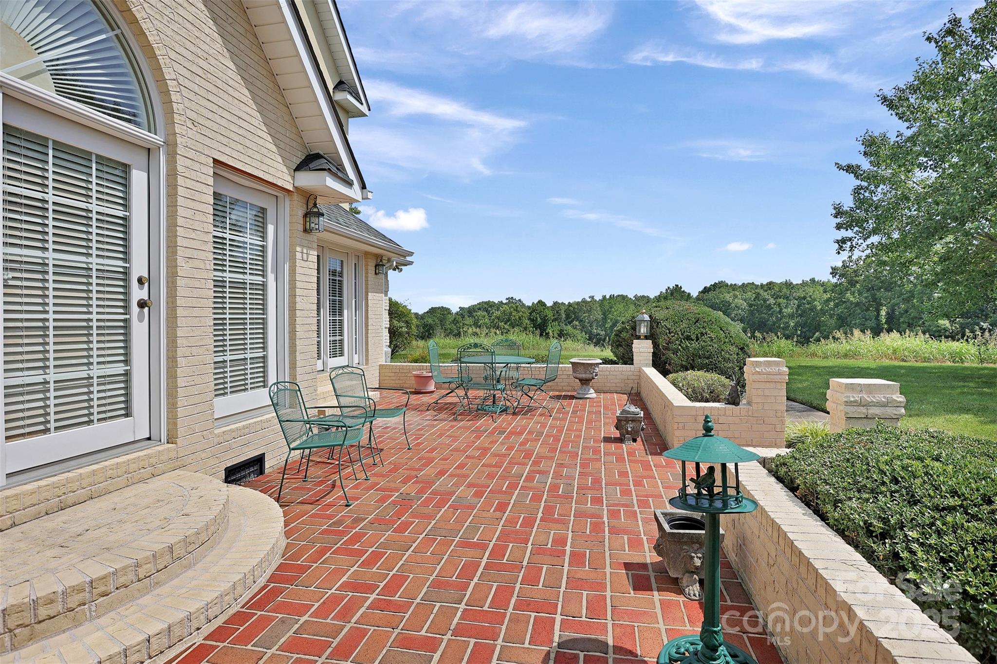 25683 April Lane Albemarle, NC 28001 - Photo 34 of 42 a view of a patio with couches and table and chairs with wooden floor and fence