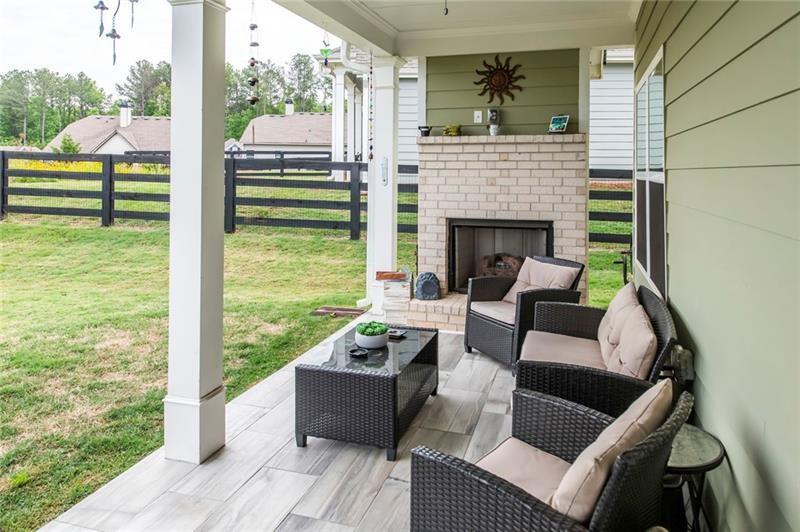 98 Heritage Pointe Drive Villa Rica, GA 30180 - Photo 16 of 48 a view of a patio with couches chairs and a floor to ceiling window