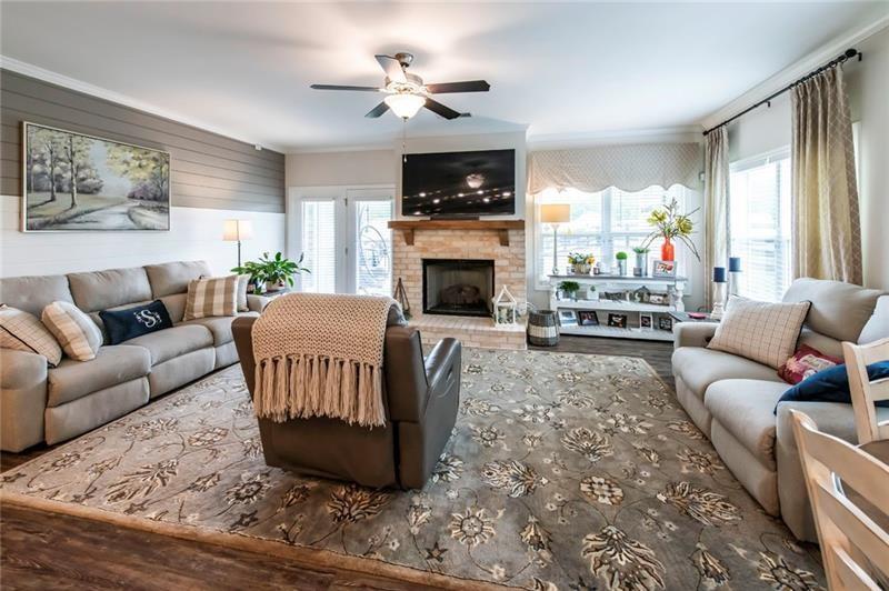 98 Heritage Pointe Drive Villa Rica, GA 30180 - Photo 20 of 48 a living room with furniture a fireplace and a large window