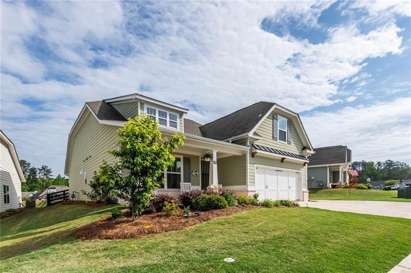 98 Heritage Pointe Drive Villa Rica, GA 30180 - Photo 2 of 48 a front view of a house with a garden