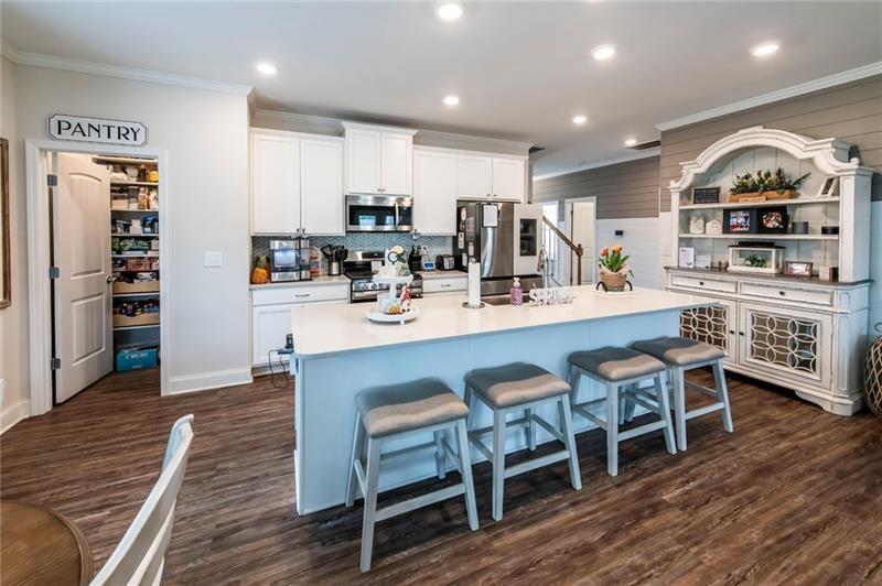 98 Heritage Pointe Drive Villa Rica, GA 30180 - Photo 23 of 48 a large kitchen with a table and chairs