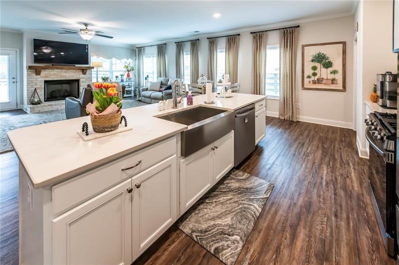 98 Heritage Pointe Drive Villa Rica, GA 30180 - Photo 26 of 48 a kitchen with a sink dishwasher stove and wooden floor