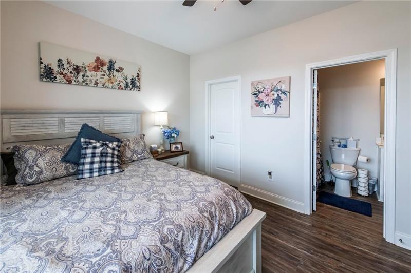 98 Heritage Pointe Drive Villa Rica, GA 30180 - Photo 38 of 48 a bedroom with a large bed and a chandelier