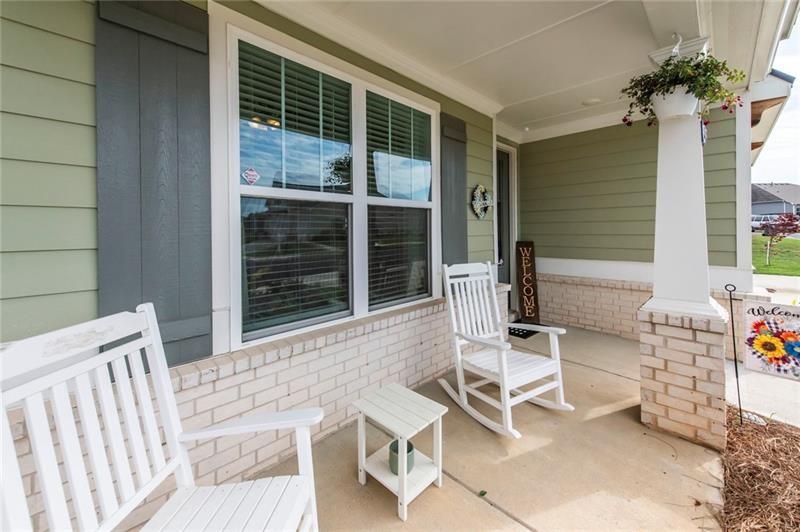 98 Heritage Pointe Drive Villa Rica, GA 30180 - Photo 6 of 48 a balcony with table and chairs and potted plants