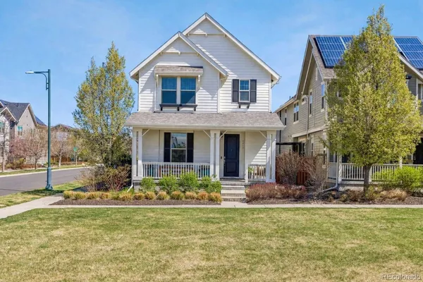 a view of a house with yard and sitting area