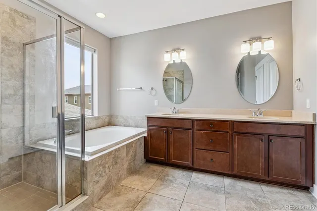 a spacious bathroom with a double vanity sink and a mirror