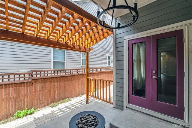 a backyard of a house with a bench and wooden floor
