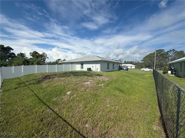 a view of house with backyard