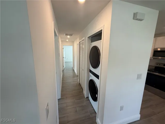 a view of a hallway with washer and dryer