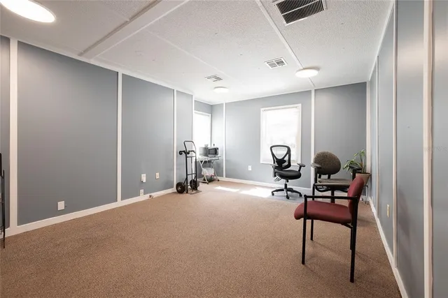 a view of a room with gym equipment and a large window
