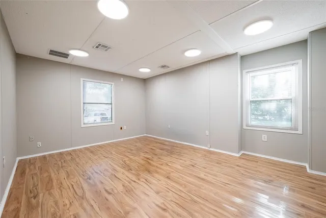 wooden floor in an empty room with a window