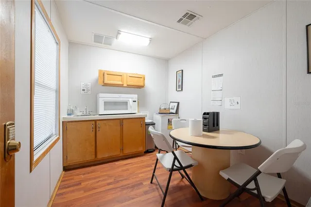 a view of a dining room with furniture and wooden floor