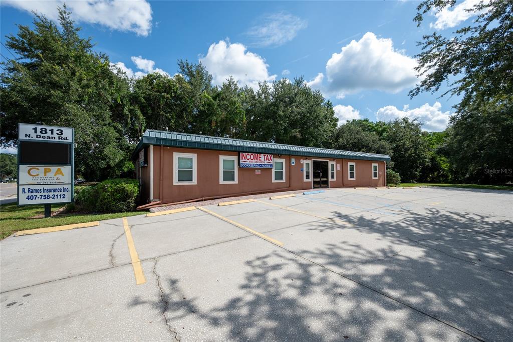 1813 North Dean Road Orlando, FL 32817 - Photo 2 of 35 a front view of a house with a yard and trees