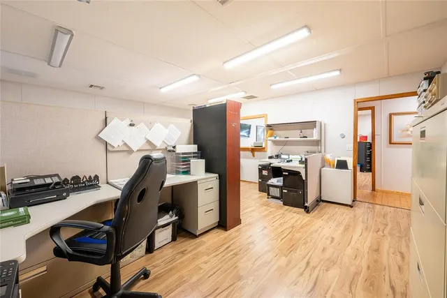 a view of a workspace with furniture and gym equipment