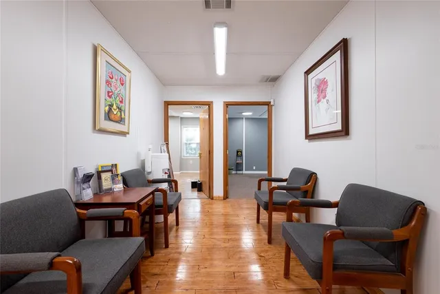 a dining room with furniture and wooden floor