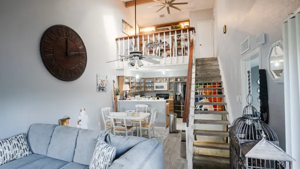a living room with furniture a fireplace and a chandelier