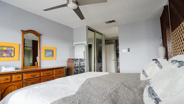 a bedroom with a bed and a dresser