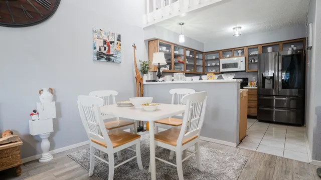 a living room with furniture a chandelier and a wooden floor