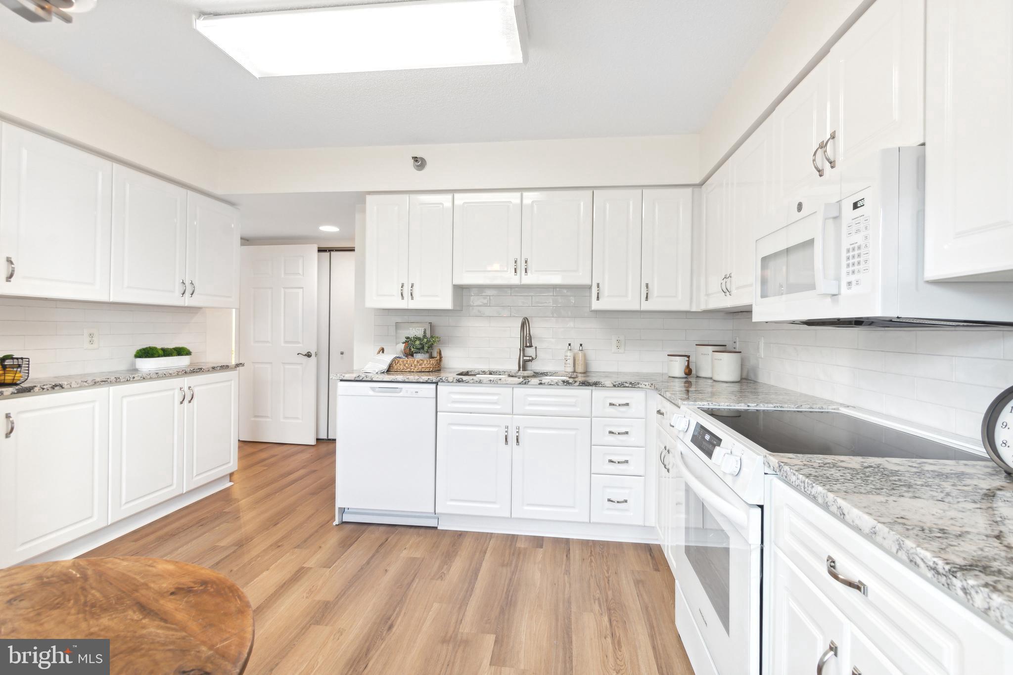 14809 Pennfield Circle, Unit 304 Silver Spring, MD 20906 - Photo 10 of 29 Bright, light filled white kitchen