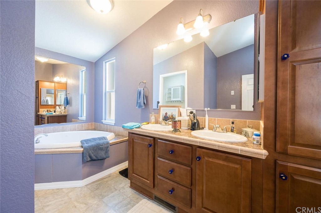 2531 Cienaga Street, Unit 3 Oceano, CA 93445 - Photo 15 of 18 a bathroom with a tub double vanity sink and mirror