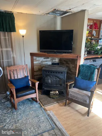 a room with furniture cabinetry and a large window