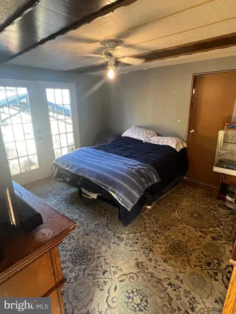 a bed sitting in a bedroom next to a window