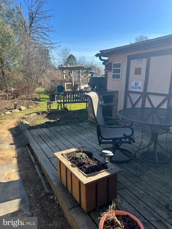 a view of a backyard with furniture and a fire pit