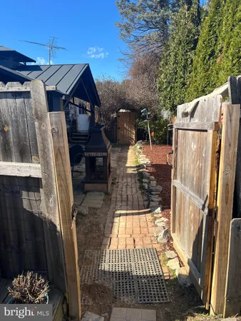 a view of a backyard with table and chairs a barbeque