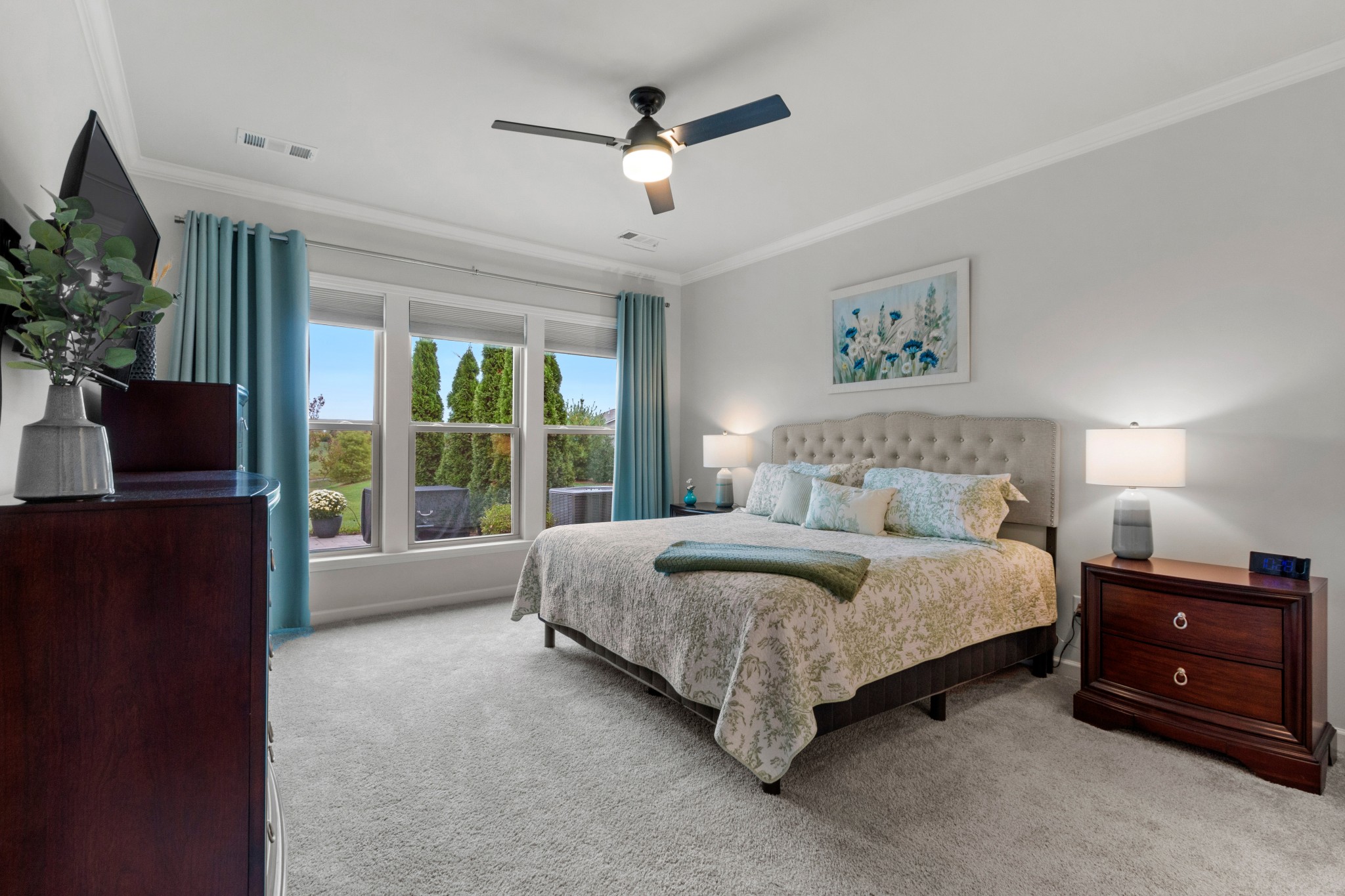 1331 Madison Lane Spring Hill, TN 37174 - Photo 26 of 61 a spacious bedroom with a bed a couch and a potted plant