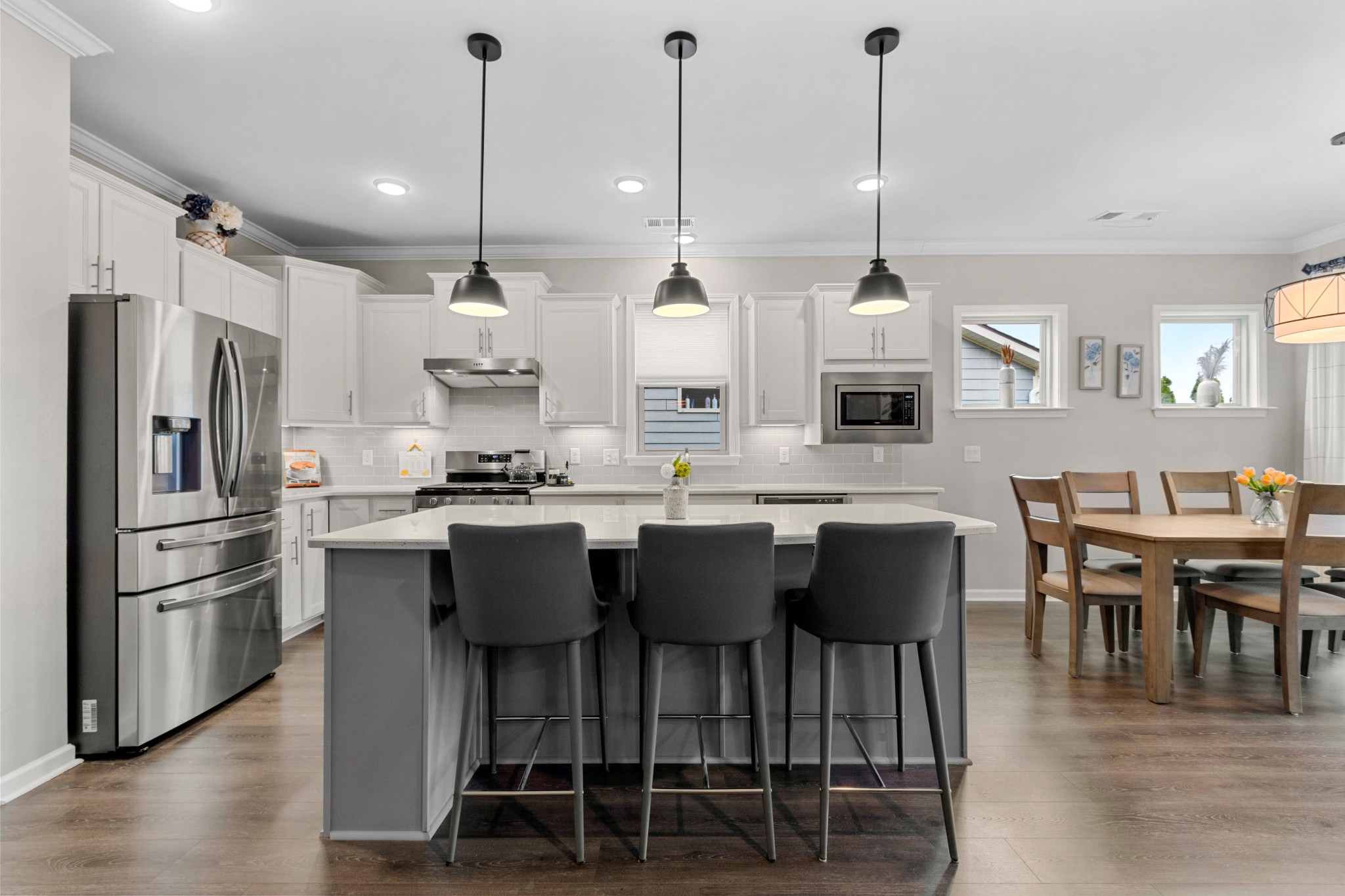 1331 Madison Lane Spring Hill, TN 37174 - Photo 10 of 61 a kitchen with stainless steel appliances kitchen island granite countertop a table chairs and a refrigerator
