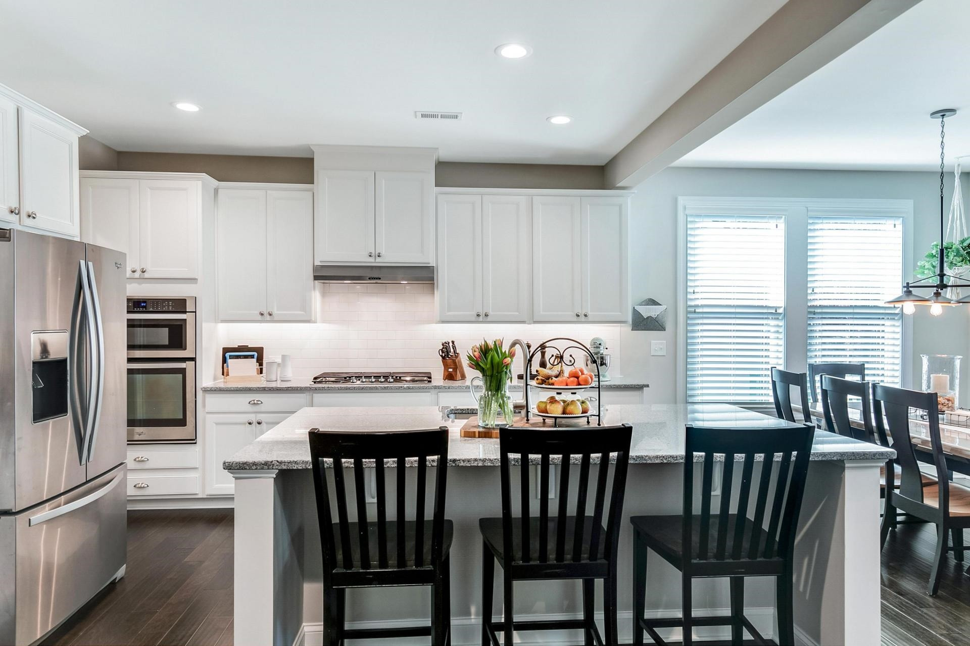 1016 Capstone Drive Durham, NC 27713 - Photo 11 of 50 a kitchen with stainless steel appliances granite countertop a stove a table and chairs