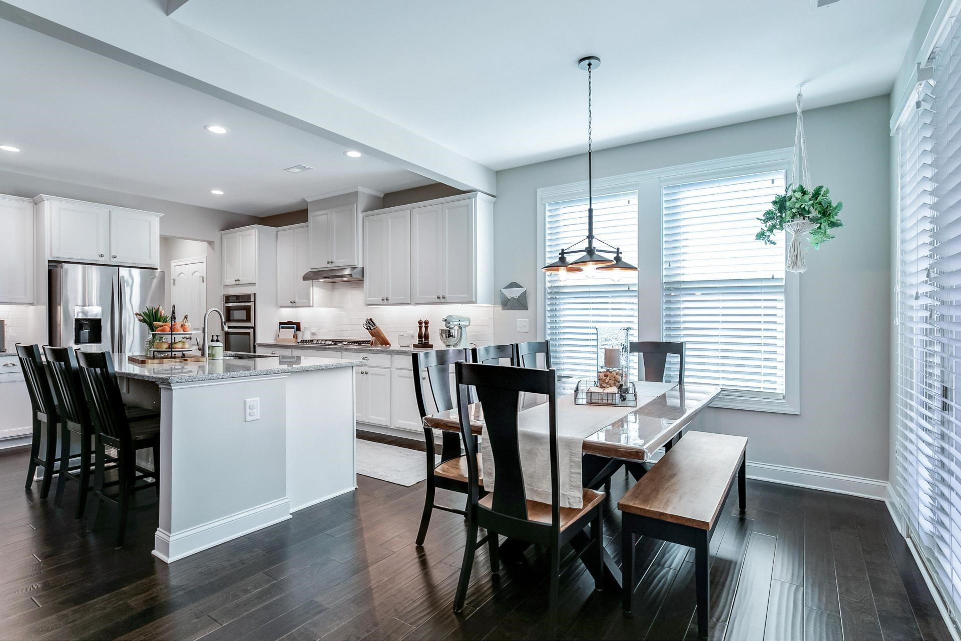 1016 Capstone Drive Durham, NC 27713 - Photo 13 of 50 a kitchen with granite countertop white cabinets dining table and chairs