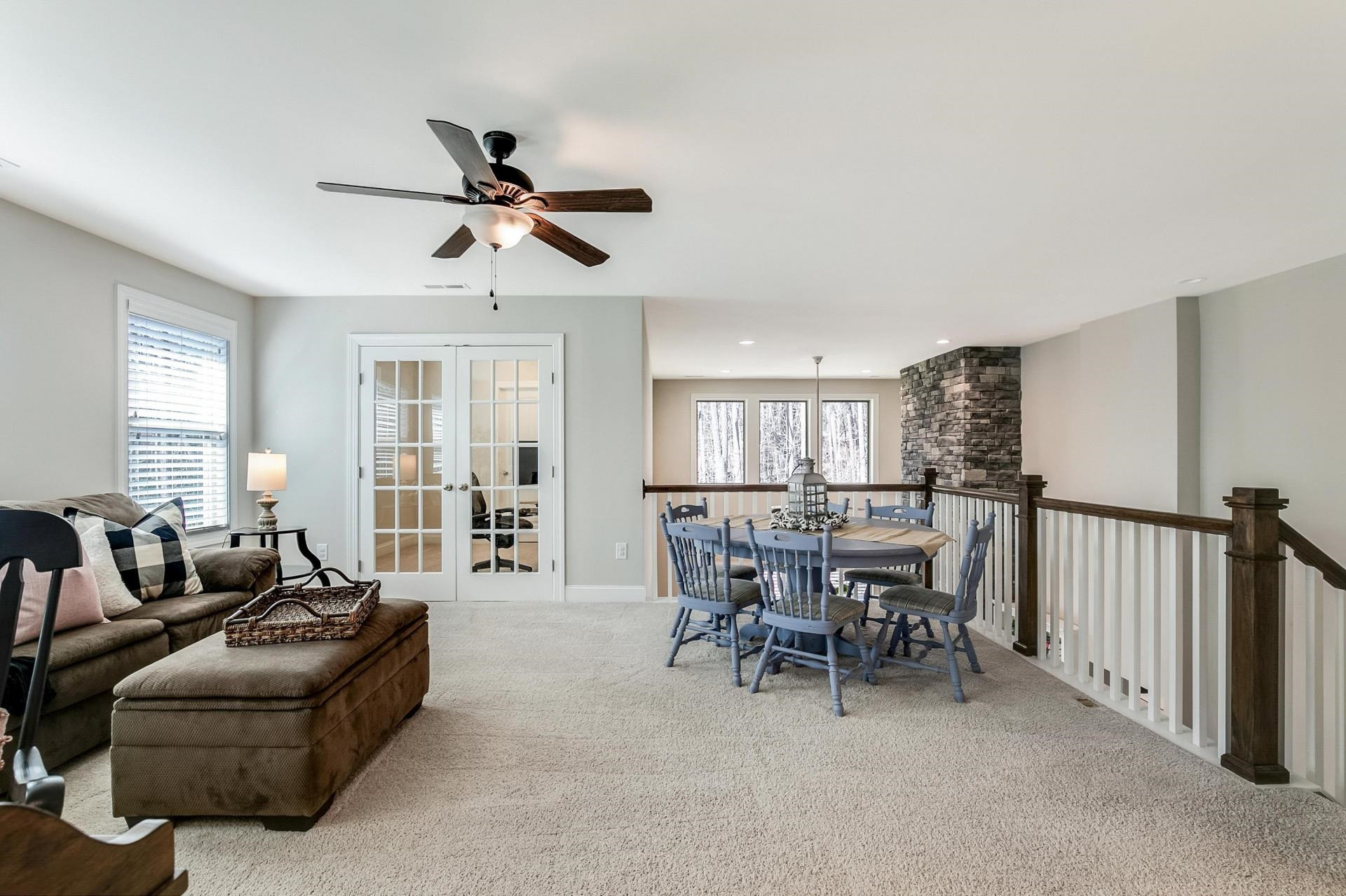 1016 Capstone Drive Durham, NC 27713 - Photo 28 of 50 a living room with furniture ceiling fan and a window
