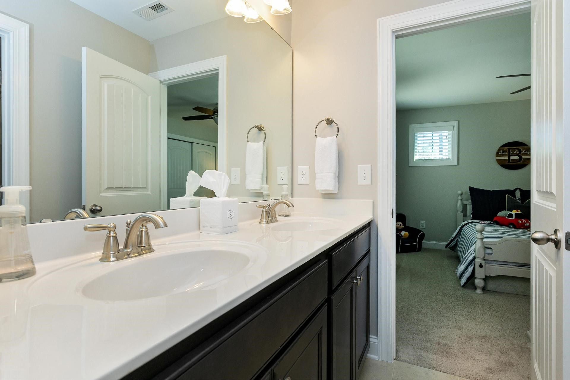 1016 Capstone Drive Durham, NC 27713 - Photo 36 of 50 a bathroom with a sink double vanity and a toilet