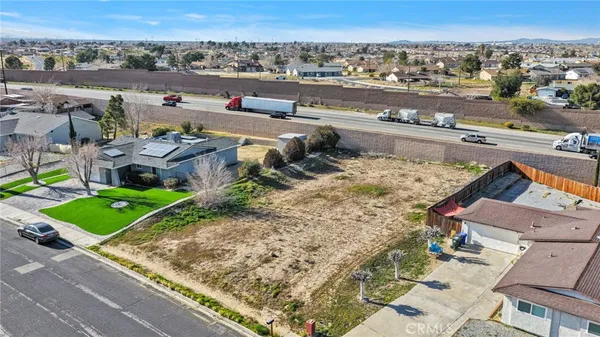 an aerial view of a house with a mountain