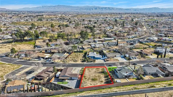 an aerial view of a residential building and street