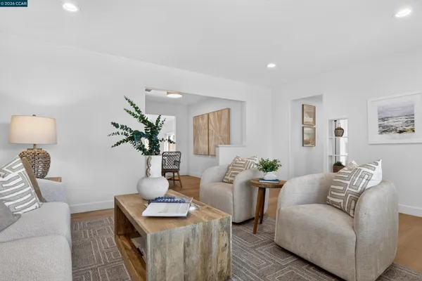 a living room with furniture and a potted plant on table