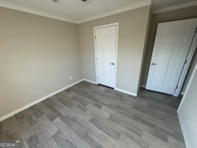 a view of a hallway with wooden floor