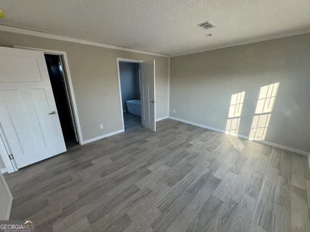 a bathroom with a granite countertop sink a mirror and a bathtub