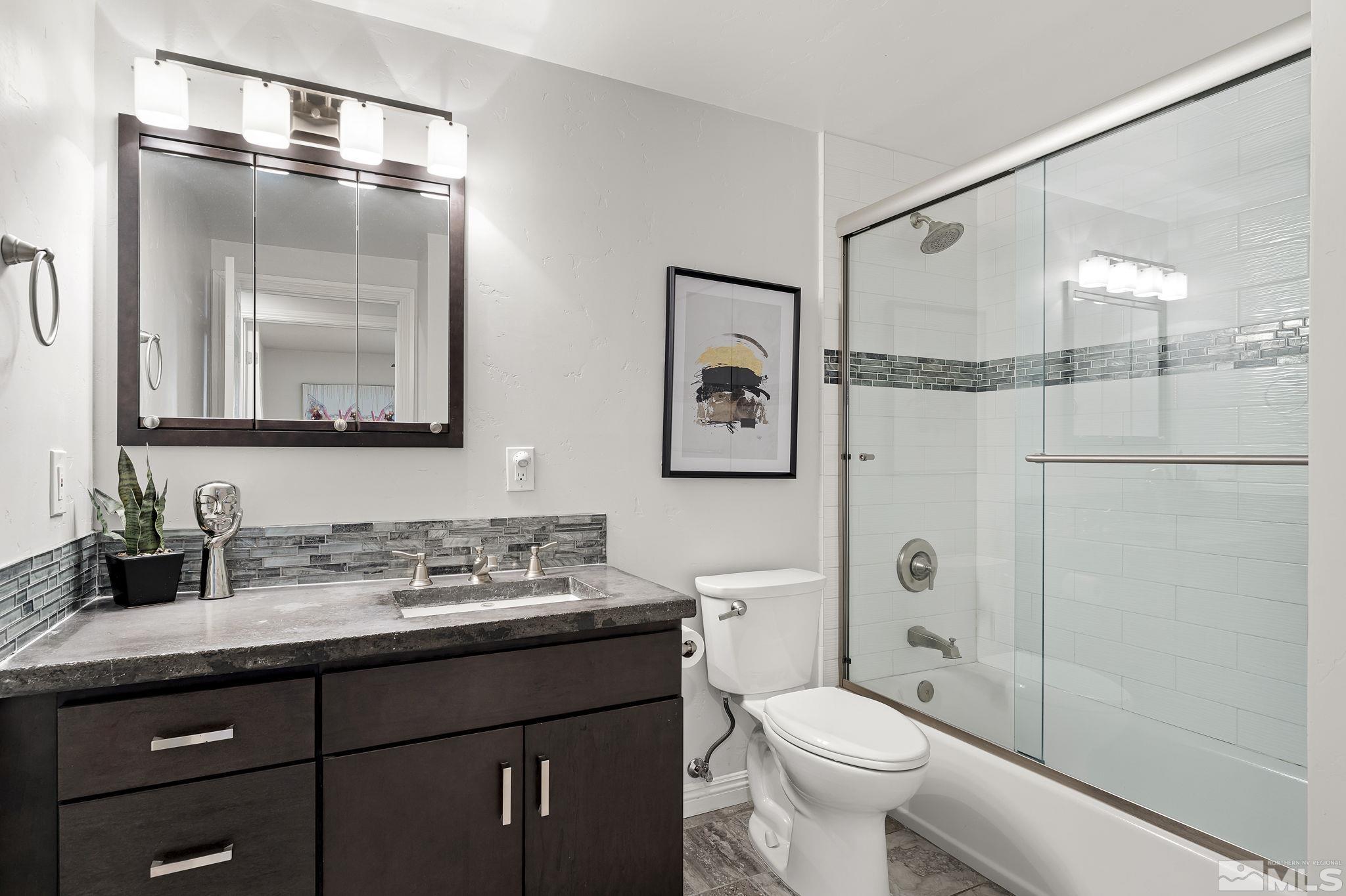 1890 Carlin Street Reno, NV 89503 - Photo 17 of 40 a bathroom with a granite countertop sink toilet and shower