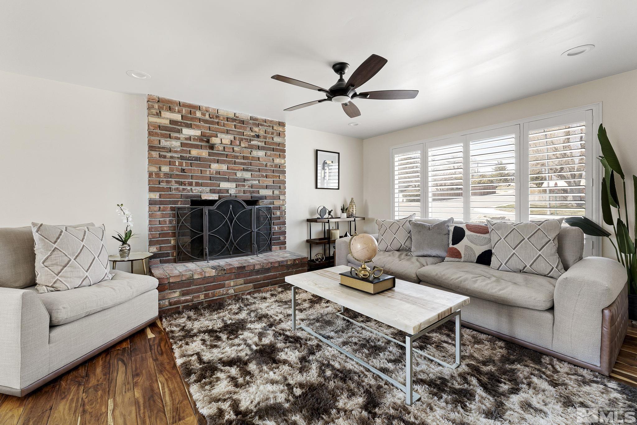 1890 Carlin Street Reno, NV 89503 - Photo 6 of 40 a living room with furniture a fireplace and a flat screen tv