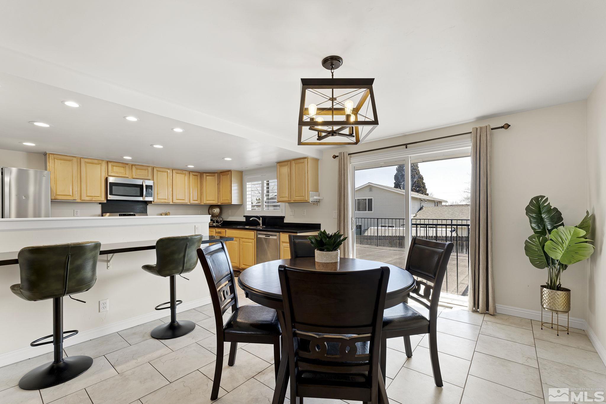 1890 Carlin Street Reno, NV 89503 - Photo 9 of 40 a dining room with furniture and a kitchen view