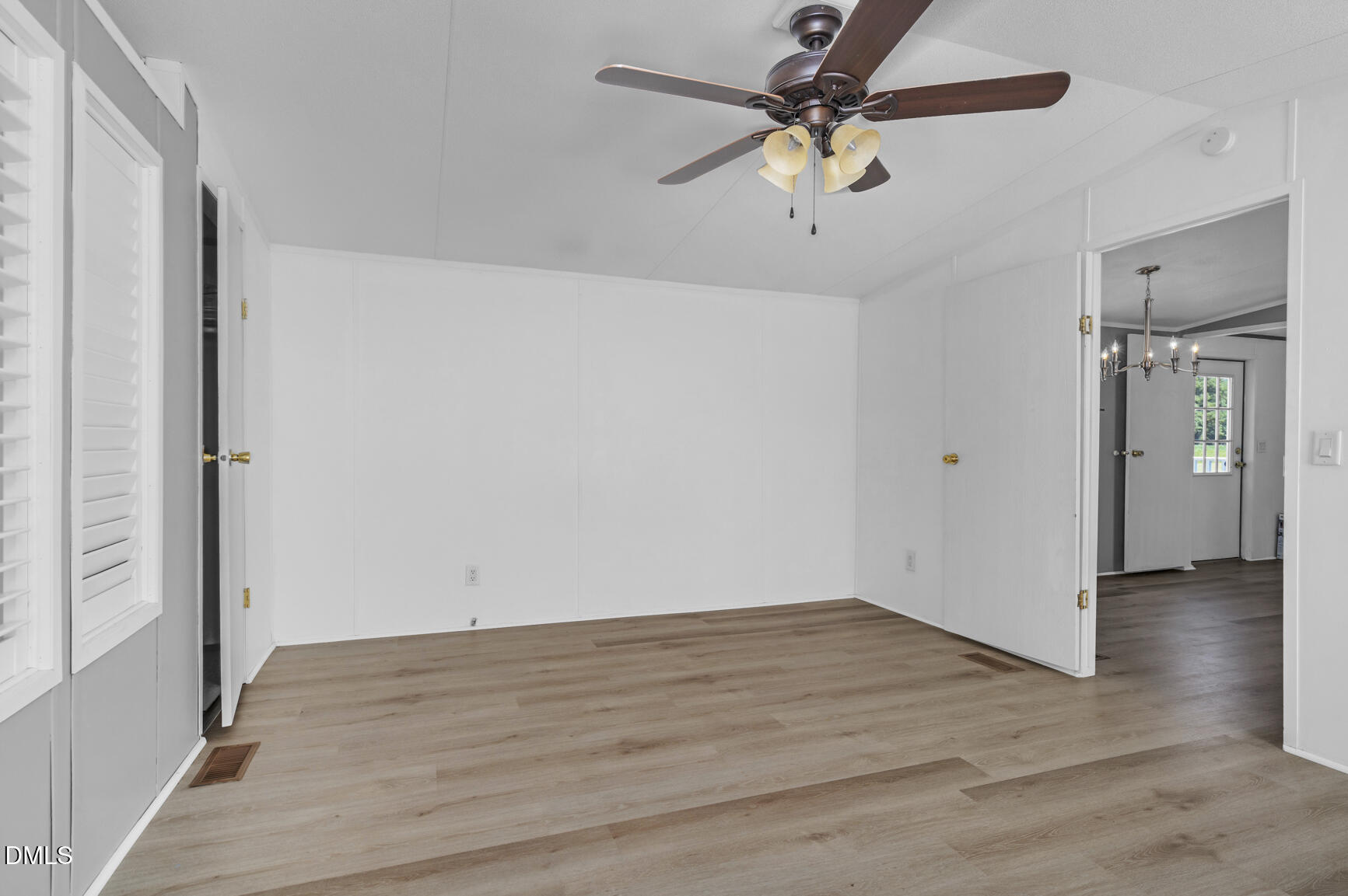 6515 Tonya Road Elm City, NC 27822 - Photo 38 of 52 an empty room with wooden floor fan and windows